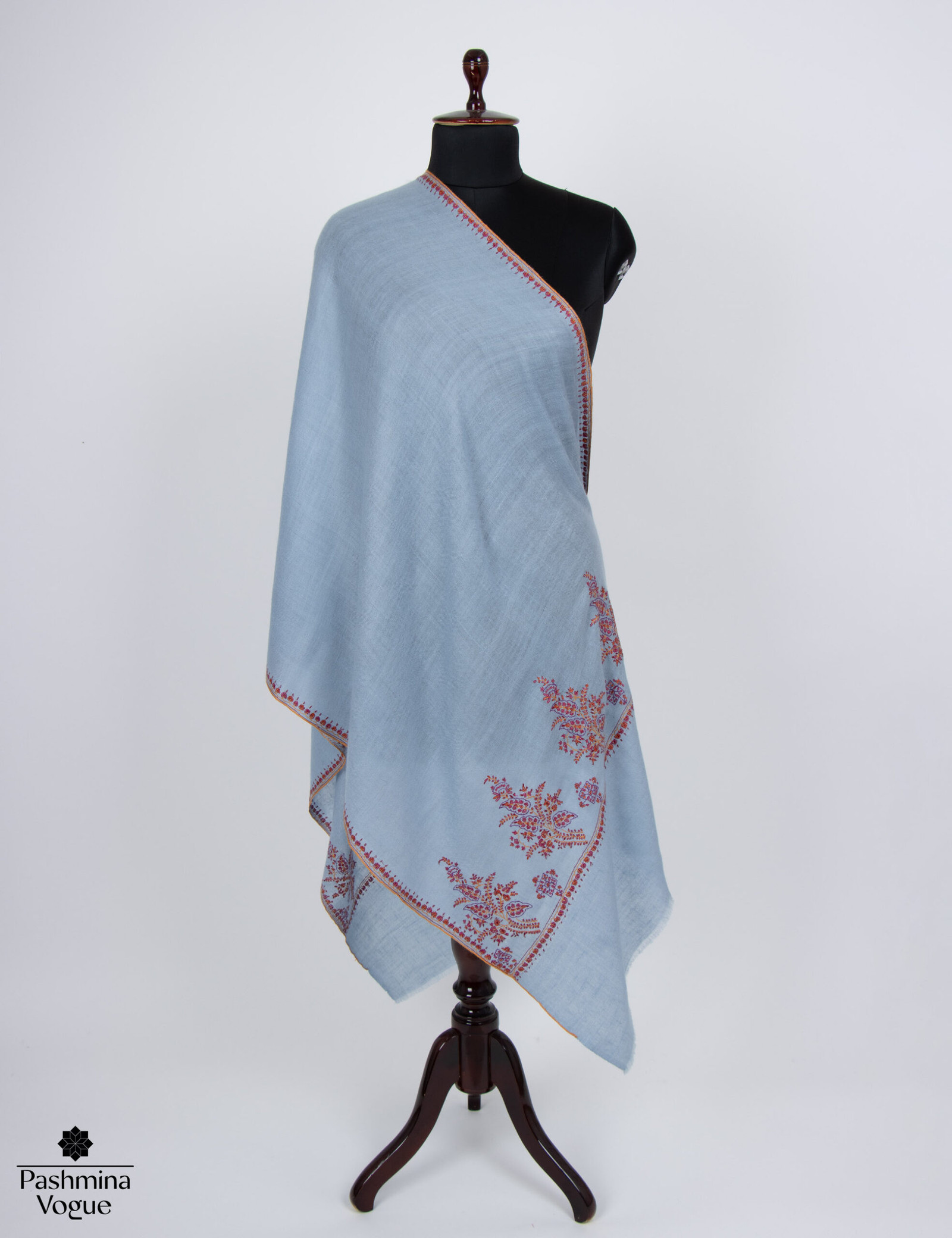 Handwoven Nepal Blue cashmere scarf with a distinct Palladar border design, draped to show its texture and color.
