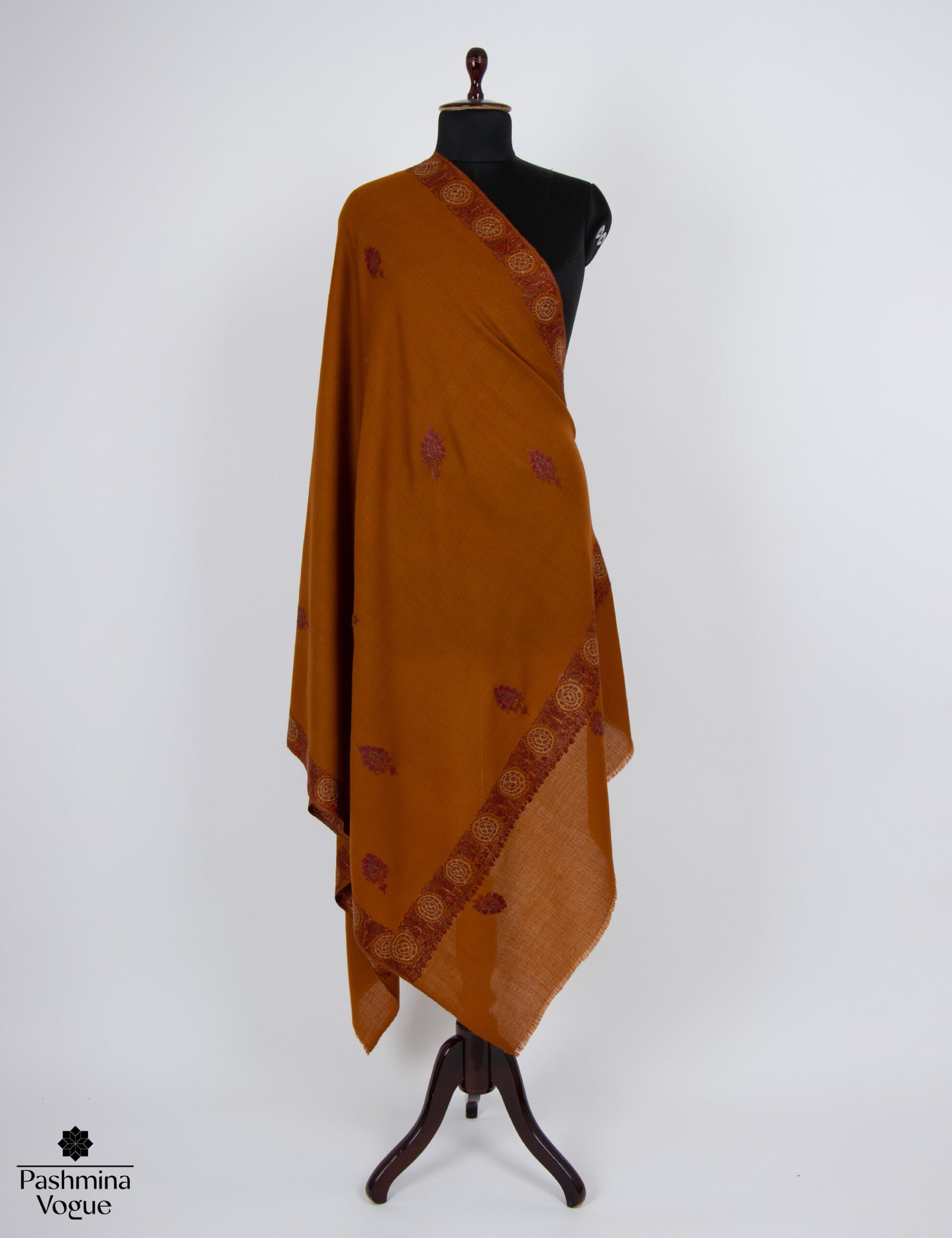 A close-up of a baby soft cashmere scarf with intricate Palla needlepoint embroidery on its ends, highlighting the detailed hand-stitched patterns.