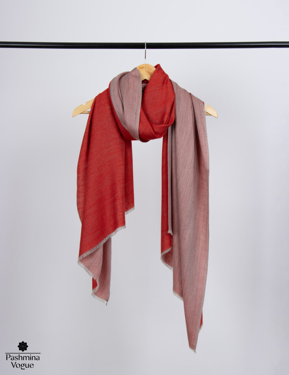 soft woolen wrap showing its dual shade reversible feature, with two complementary tones of red, perfect as a gift for her.