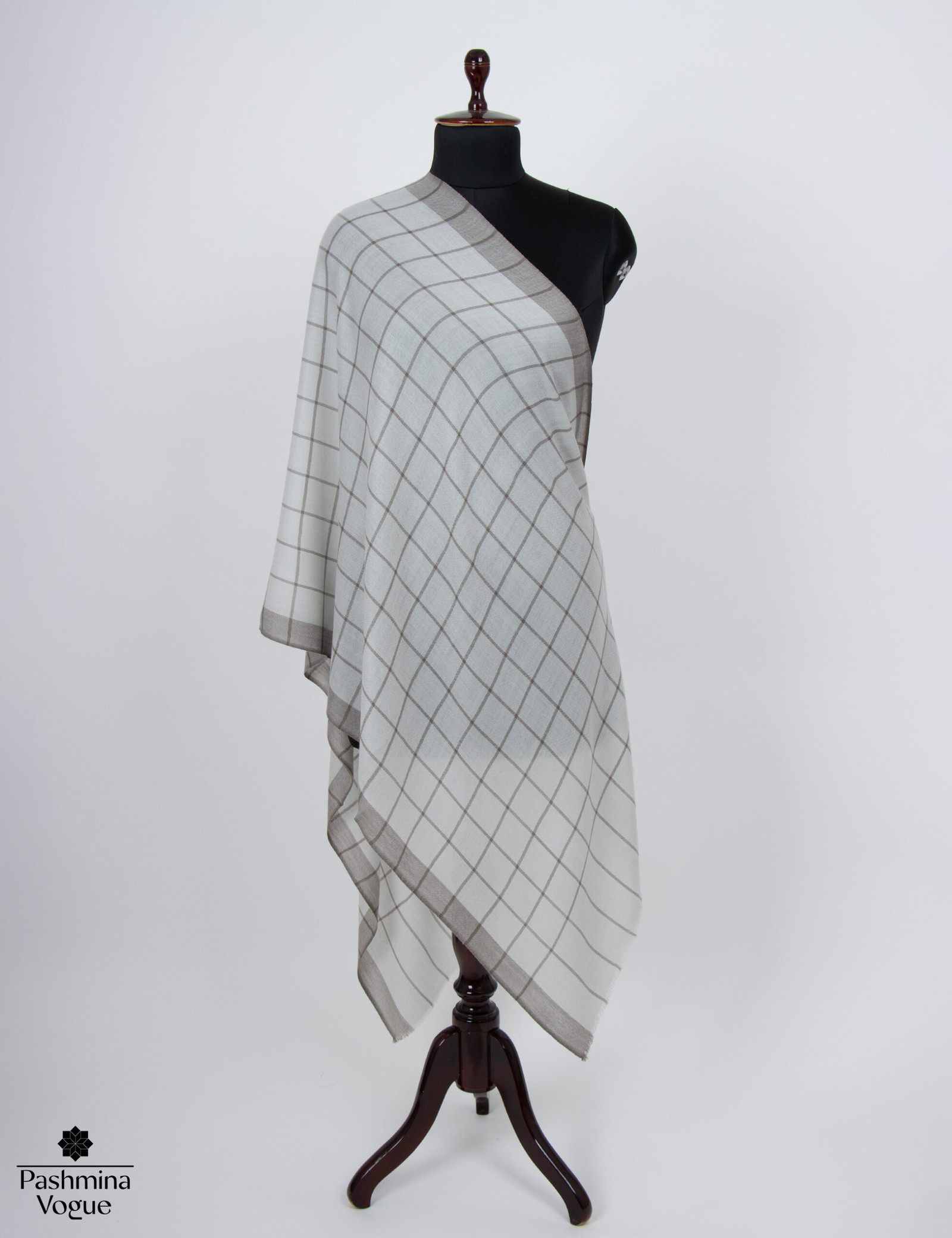 Merino wool shawl featuring a classic gray check pattern, highlighting its cozy texture and elegant style, perfect as a luxury winter gift.