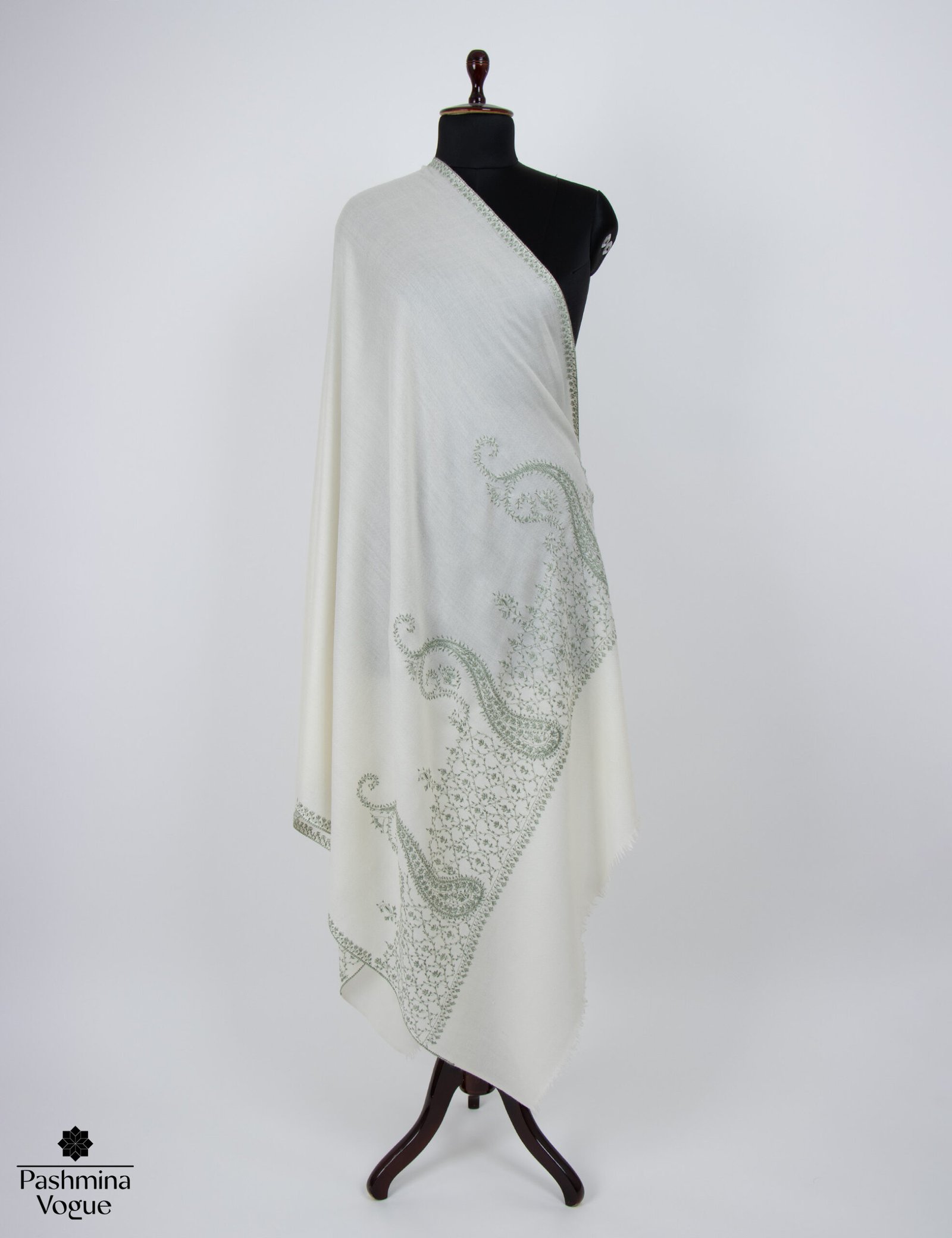 hand-embroidered white wool pashmina shawl with mint-green Kashmiri Sozni needlework and fringe, showcasing the soft texture and detailed paisley motifs.