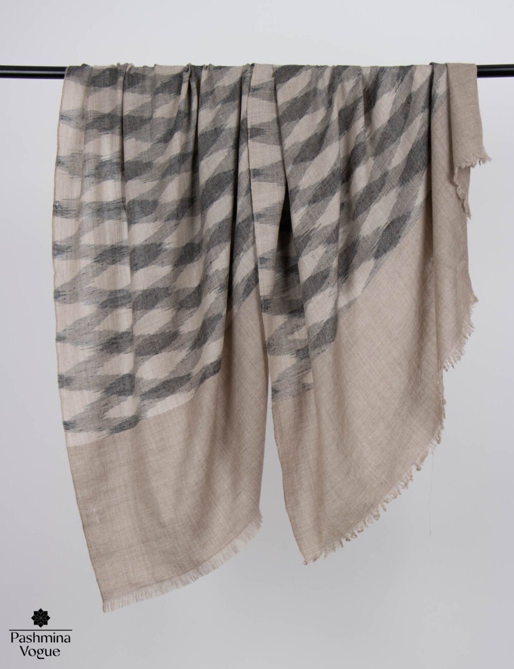Authentic handloomed Ikat Pashmina shawl showcasing sharp geometric resistance dye patterns.