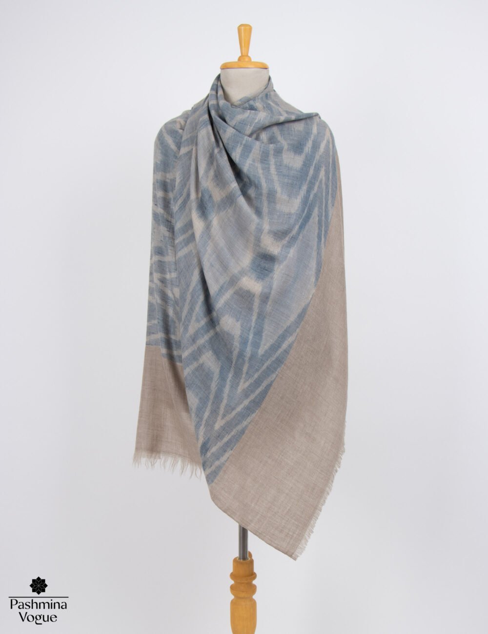 Handwoven Ikat Pashmina shawl showcasing sharp modern geometric tie-dye patterns in rich artisan hues.