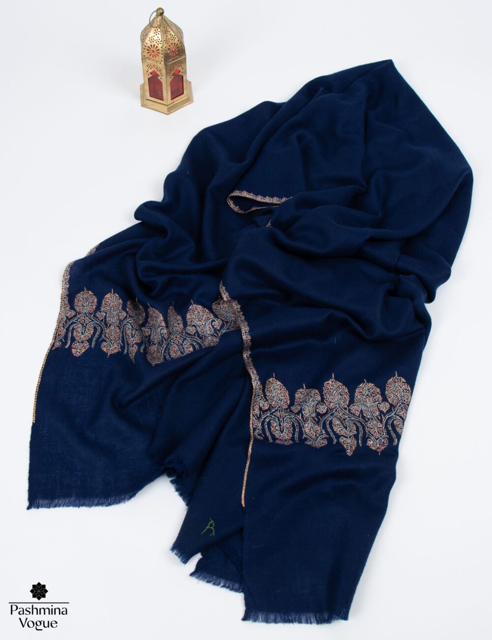 Elegant navy blue wrap for weddings draped gracefully as an evening shawl over a formal dress.