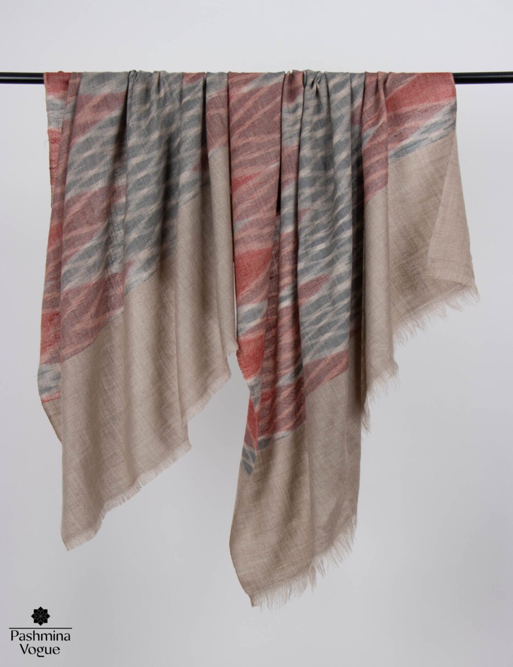 Women's Ikat Pashmina scarf in a modern geometric pattern styled as a sustainable luxury fashion accessory.