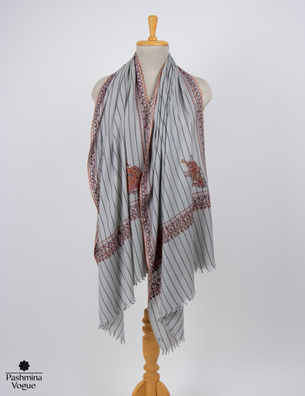 Hand embroidered wool scarf displayed as an authentic artisan evening stole with Kashmiri Sozni needlework.